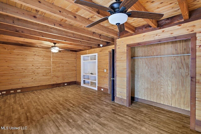 unfurnished bedroom with beam ceiling, hardwood / wood-style flooring, wood ceiling, and wood walls