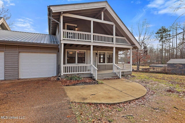 view of front of home with a porch and a garage