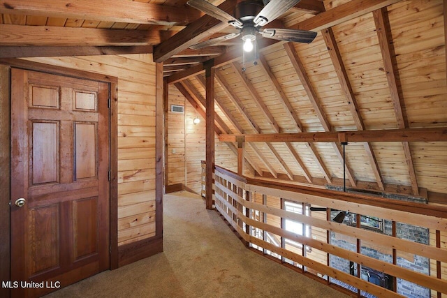 additional living space featuring lofted ceiling with beams, wood ceiling, and wooden walls