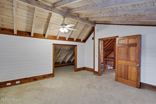 bonus room with wood walls, wooden ceiling, light carpet, vaulted ceiling with beams, and ceiling fan