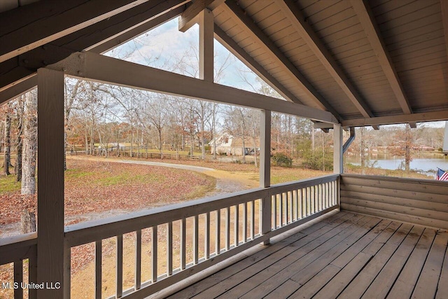 wooden terrace featuring a water view