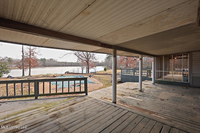 deck featuring a sunroom and a water view