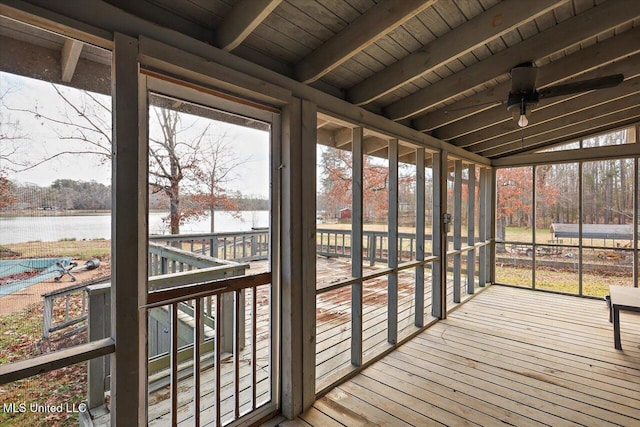 unfurnished sunroom featuring vaulted ceiling with beams, a water view, and wood ceiling