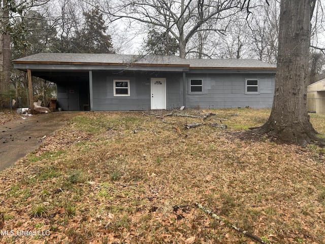 single story home featuring a carport and driveway