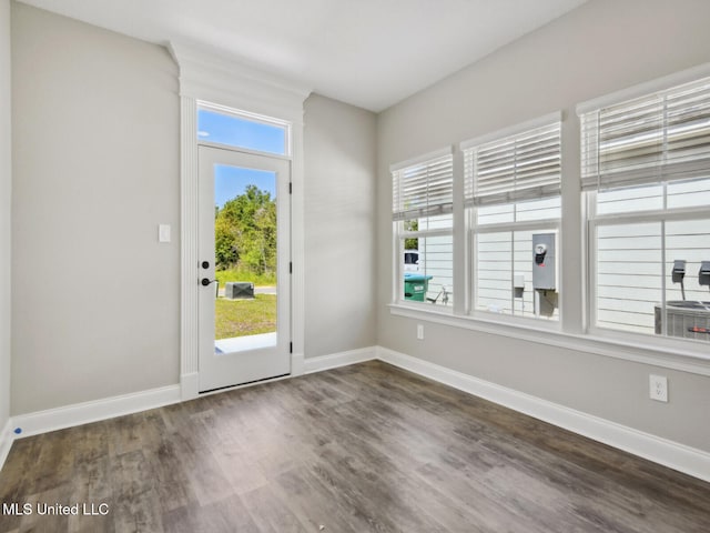 130 Everly Cir, Ocean Springs, MS 39564 - doorway to outside featuring dark wood-style flooring, a healthy amount of sunlight, and baseboards