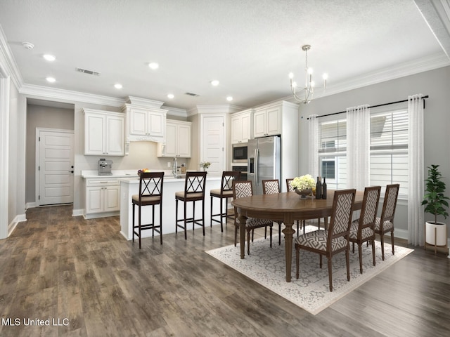 130 Everly Cir, Ocean Springs, MS 39564 - dining space with crown molding, visible vents, a chandelier, and dark wood-type flooring
