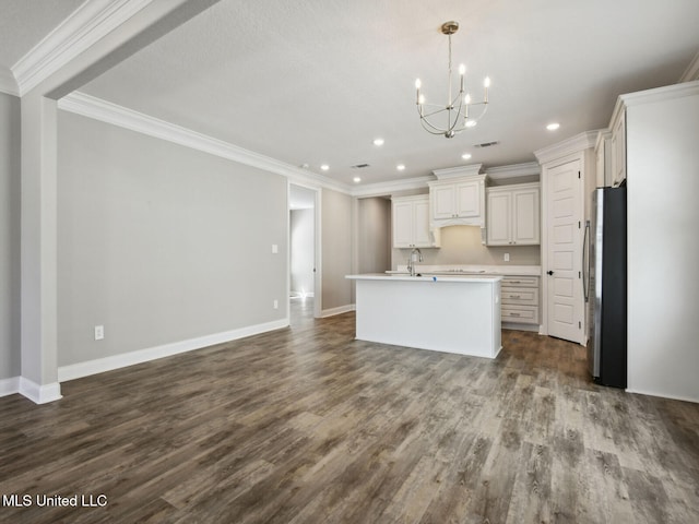 130 Everly Cir, Ocean Springs, MS 39564 - kitchen with a notable chandelier, light countertops, freestanding refrigerator, open floor plan, and an island with sink