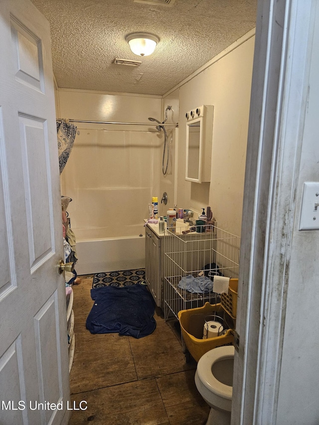 8800 Graham Rd, Moss Point, MS 39562 - full bath featuring toilet, shower / tub combo with curtain, a textured ceiling, and wood finished floors