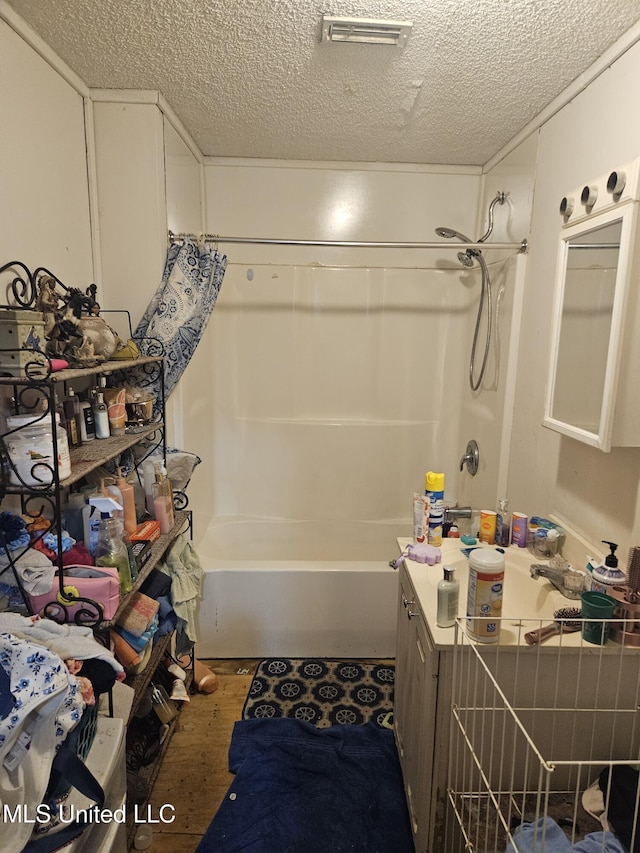 8800 Graham Rd, Moss Point, MS 39562 - bathroom with wood finished floors, a textured ceiling, tub / shower combination, and vanity