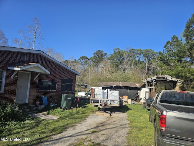 8800 Graham Rd, Moss Point, MS 39562 - view of side of property featuring brick siding and a lawn