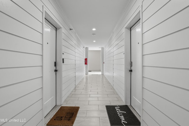 hallway with a package area and recessed lighting