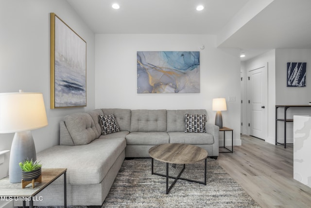 living area featuring recessed lighting, baseboards, and wood finished floors