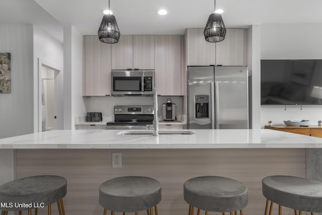 kitchen featuring appliances with stainless steel finishes, modern cabinets, and pendant lighting