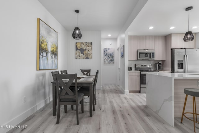 dining area with light wood finished floors, recessed lighting, and baseboards