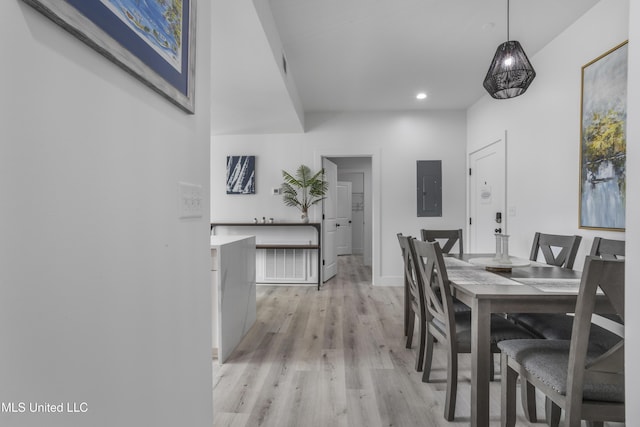 dining room with recessed lighting, light wood-type flooring, electric panel, and baseboards