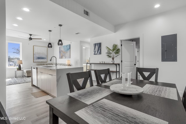 dining room featuring visible vents, light wood finished floors, electric panel, and recessed lighting