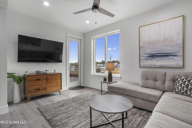 living area with baseboards, light wood-type flooring, a ceiling fan, and recessed lighting