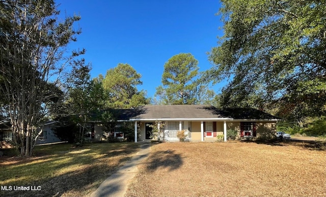 ranch-style home with covered porch and a front lawn