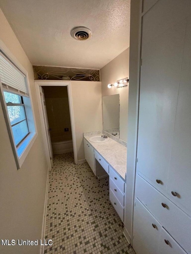 bathroom featuring vanity and a textured ceiling