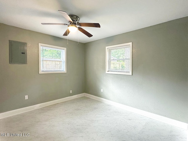 spare room featuring electric panel and ceiling fan