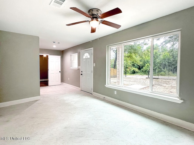 interior space with ceiling fan