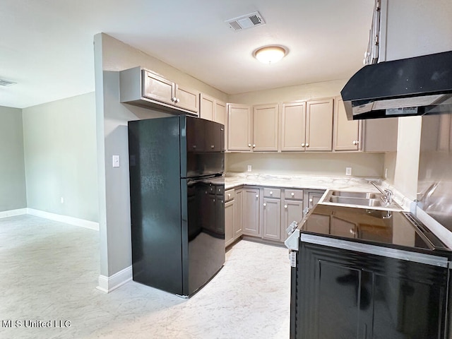 kitchen with gray cabinetry, sink, and black refrigerator