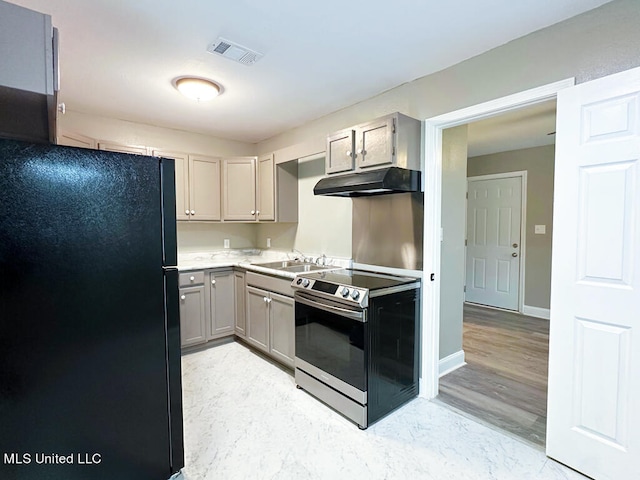 kitchen with light hardwood / wood-style flooring, electric range, black fridge, and gray cabinets