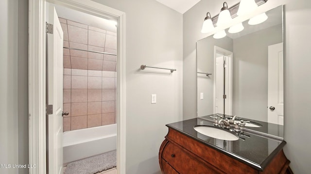 bathroom featuring vanity and shower / bath combination