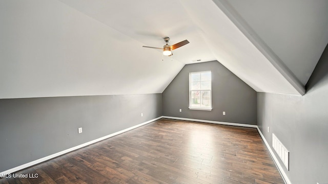 additional living space featuring a ceiling fan, vaulted ceiling, wood finished floors, and baseboards