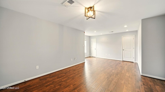 empty room featuring wood finished floors, baseboards, and recessed lighting