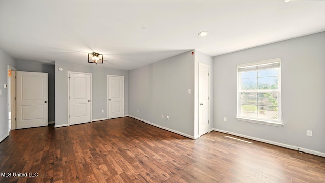 unfurnished room with baseboards, wood finished floors, and recessed lighting