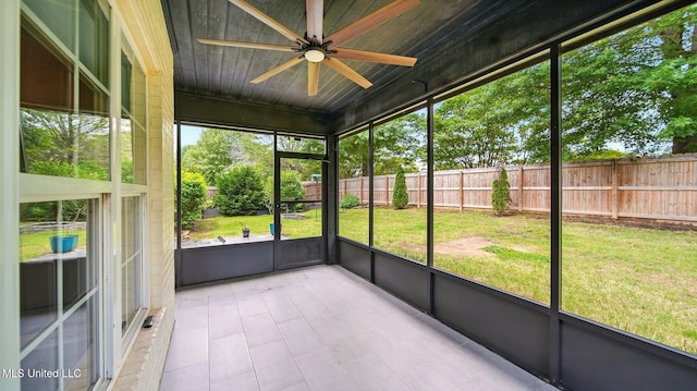 unfurnished sunroom featuring a ceiling fan