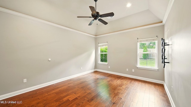 spare room with baseboards, wood-type flooring, ceiling fan, and crown molding