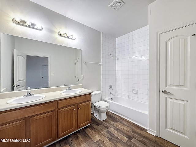 7011-13 W Marion St, Bay Saint Louis, MS 39520 - bathroom with double vanity, wood finished floors, and shower / bath combination