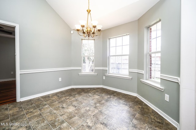 spare room featuring a notable chandelier