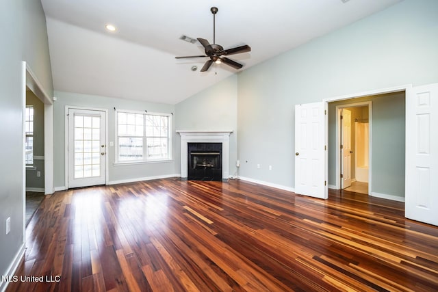 unfurnished living room with high vaulted ceiling, ceiling fan, dark hardwood / wood-style flooring, and a tile fireplace