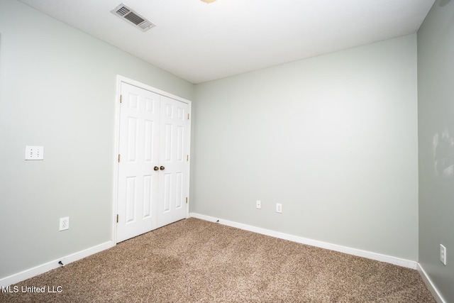 unfurnished bedroom featuring a closet and carpet floors