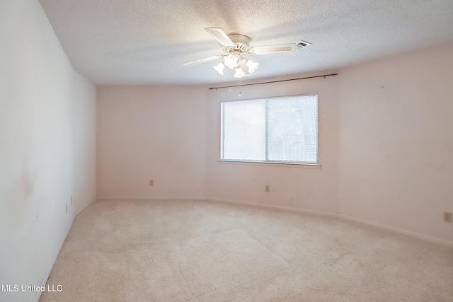 carpeted empty room with a textured ceiling and ceiling fan