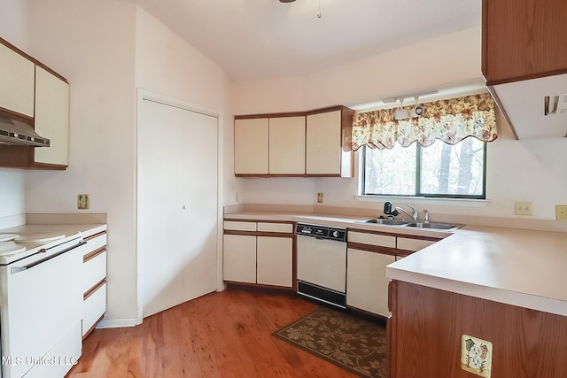 kitchen with dishwasher, range, light hardwood / wood-style floors, sink, and cream cabinets