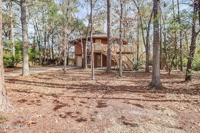 exterior space featuring a garage and a wooden deck