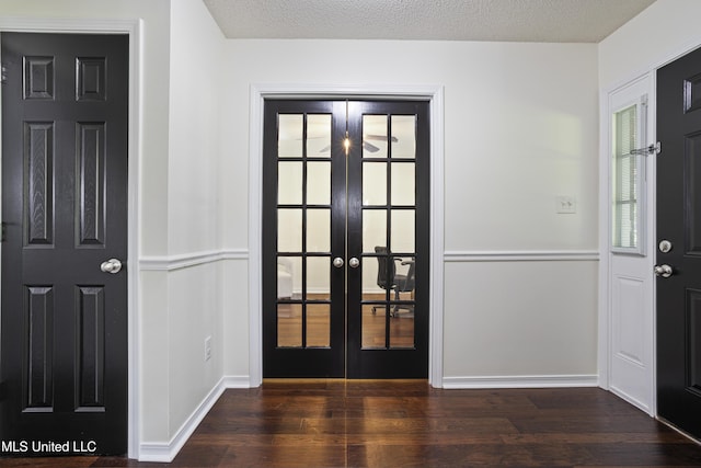 entryway featuring a textured ceiling, baseboards, french doors, and wood finished floors