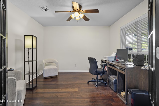office space with visible vents, baseboards, ceiling fan, and wood finished floors