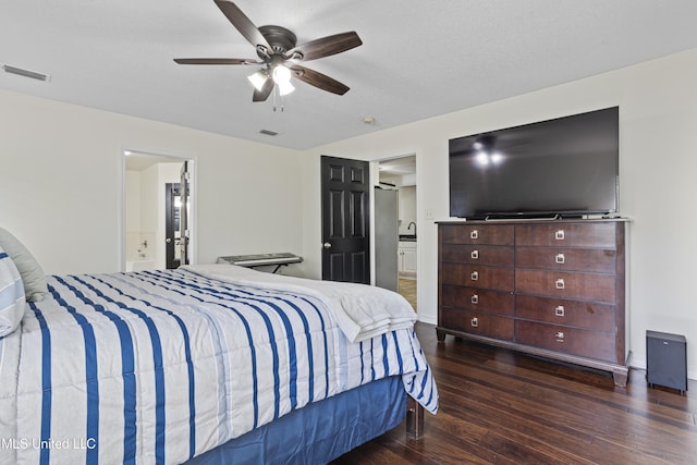 bedroom with visible vents, a ceiling fan, connected bathroom, and wood finished floors