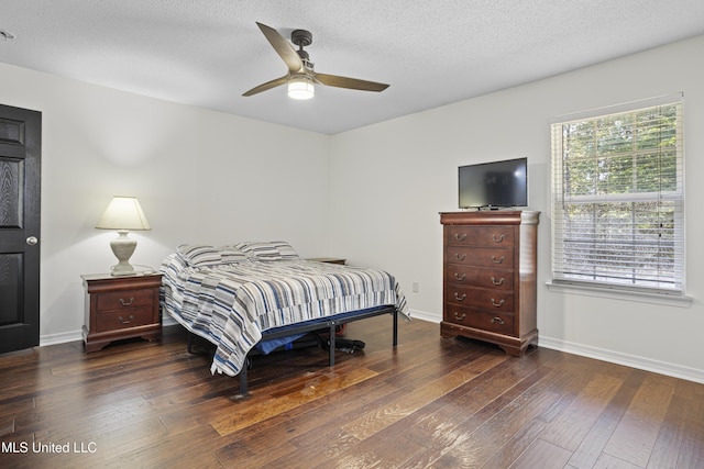 bedroom with a ceiling fan, baseboards, a textured ceiling, and hardwood / wood-style floors