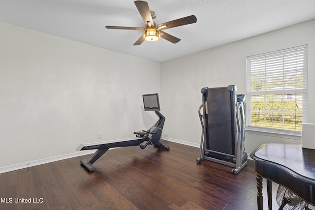 exercise room featuring baseboards, ceiling fan, and wood finished floors
