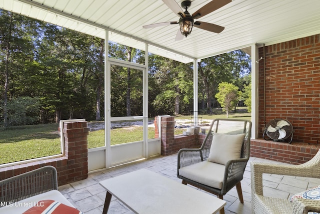 sunroom with a ceiling fan and a wealth of natural light