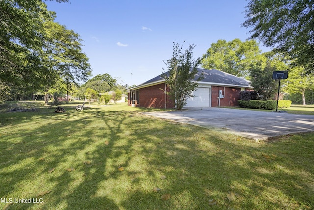 view of side of property with a lawn, driveway, and a garage