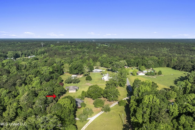 drone / aerial view with a wooded view