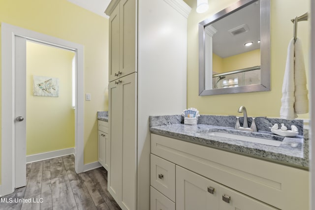 bathroom featuring vanity, an enclosed shower, and hardwood / wood-style floors