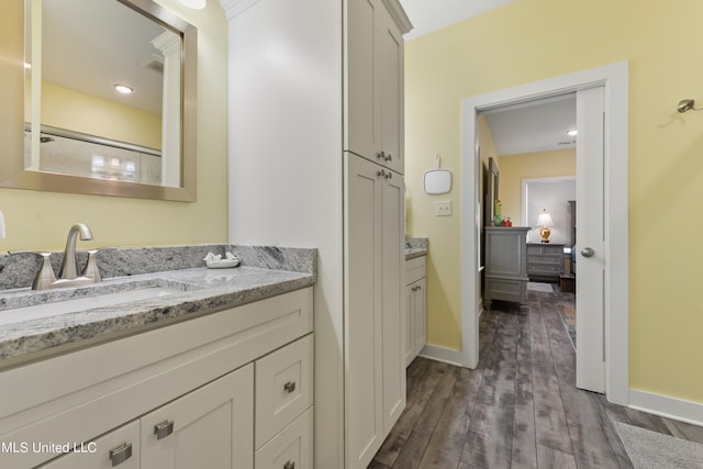 bathroom with vanity and hardwood / wood-style floors